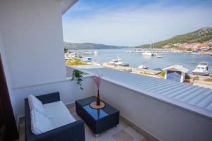 a balcony with a couch and a view of a harbor at Villa Samac in Trogir