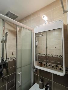 a bathroom with a shower and a sink and a mirror at Studio Sunset - Biarritz in Biarritz