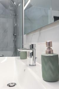 a bathroom counter with a sink and a mirror at S&V Luxury Apartment in Sfakaki