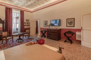 a living room with a couch and a tv at Palazzo Rotati in Fano