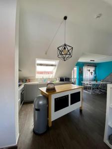 a kitchen with a table in the middle of a room at Light flow stylish attic house. m. balcony in Rastatt
