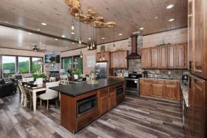 a kitchen with wooden cabinets and a dining room at Majestic Pines Lodge in Sevierville