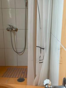 a shower with a shower curtain in a bathroom at Sea view studio in Kírra