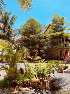 a house with a bunch of plants in front of it at Villa Pich Boutique in Kampot