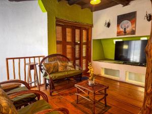 a living room with a couch and a tv at El Castillo de Panajachel 6ppl in Panajachel