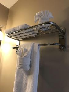 a towel rack with towels on it in a bathroom at Pacific Rim Guest Lodge - Adults Only in Ucluelet