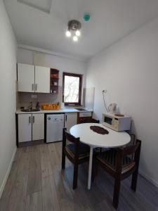 a kitchen with a table and chairs and a microwave at FERA Apartments in Sarajevo