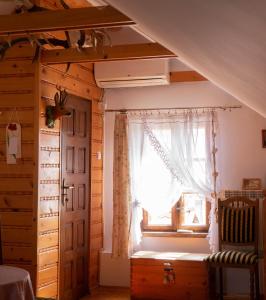 a bedroom with a window and a bed and a door at Domek myśliwski na wsi in Przemyśl +31 photos