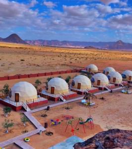 an aerial view of a group of domes in the desert at Adel rum camp bubbles in Wadi Rum