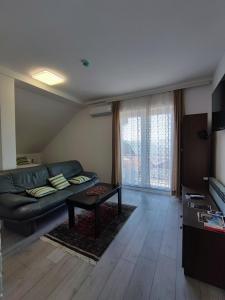 a living room with a couch and a table at FERA Apartments in Sarajevo