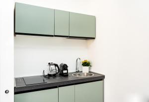 a kitchen with a sink and a cabinet at La maison de tante Rosa in Siracusa