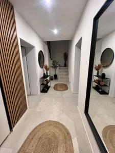 a hallway with two mirrors and rugs in a room at AURA Hlinsko in Hlinsko