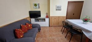 a living room with a couch and a table at Casa Rural San Marcos in Cepeda