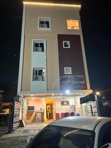 a building with a car parked in front of it at Airport Hotel Relax Inn in Nagpur