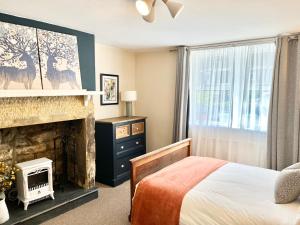 a bedroom with a bed and a fireplace at Inviting townhouse in Bedlington in Bedlington