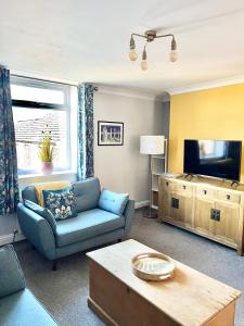 a living room with a couch and a tv at Inviting townhouse in Bedlington in Bedlington
