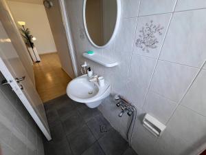 a bathroom with a white sink and a mirror at STUDIO in Limassol