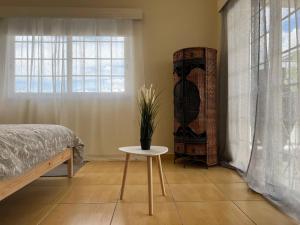 a bedroom with a bed and a table and a window at STUDIO in Limassol +3 photos