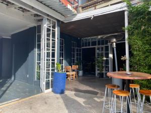a patio with stools and a table and chairs at 9 Living Moad Maboneng in Johannesburg