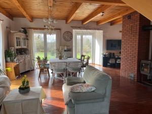 a living room with a couch and a table in it at Drewniany dom w Borach Tucholskich "Twoja Ostoja" in Brusy