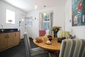 a kitchen and dining room with a table and chairs at Ferndale Cottage in Lynmouth