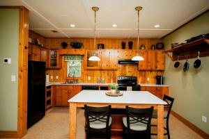 una cucina con tavolo e frigorifero nero di Private Garage Apartment a Commerce