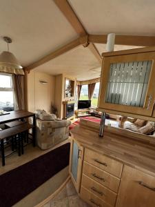 a living room with a kitchen and a dining room at Bay 1 in Kirkcolm