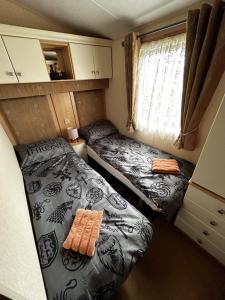 a small room with two beds and a window at Bay 1 in Kirkcolm +30 photos