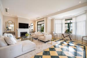 un soggiorno con mobili bianchi e pavimento a scacchi di Villa Shakira, Sierra Blanca, Marbella a Marbella
