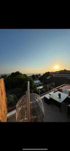 a view of a balcony with a table and chairs at Pool Rooftop Kadikoy Bagdat St. Seaside metro 5mins Metro in Istanbul