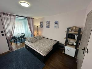 a bedroom with a bed and a table in it at Appart O'key in Lure