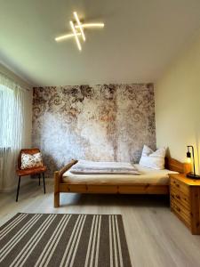 a bedroom with a bed and a wall at Mit Blick auf eines der schönsten Geotope Bayerns in Solnhofen