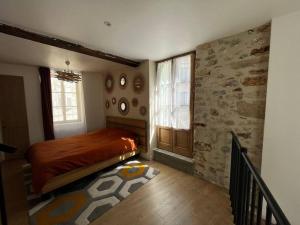a bedroom with a bed and a window in it at Maison suspendue avec jacuzzi privatif in Pont-en-Royans