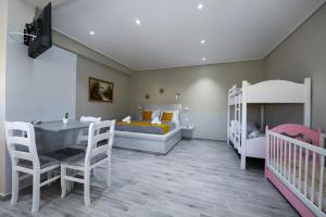a bedroom with two bunk beds and a crib at Guest House Narta in Vlorë
