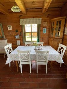 a dining room with a table and chairs at Őrségi Mi Kis Házunk vendégház in Szalafő