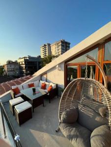 a balcony with a couch and a swing at Pool Rooftop Kadikoy Bagdat St. Seaside metro 5mins Metro in Istanbul