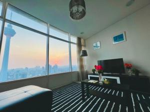 a living room with a view of a city at VORTEX KLCC Apartment Kuala Lumpur Bukit Bintang in Kuala Lumpur