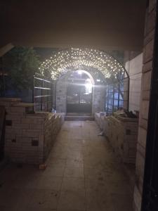a building with an arch with lights on it at USERSEEF in Cairo