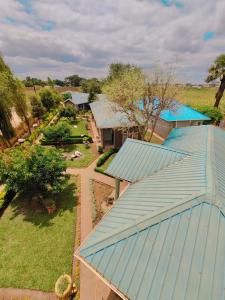 an overhead view of a house with a blue roof at Bukari Executive Lodge in Mpongwe