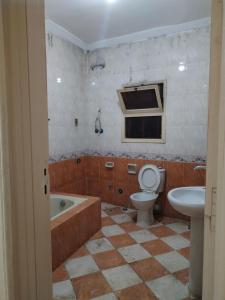a bathroom with a tub and a toilet and a sink at USERSEEF in Cairo +27 photos