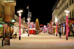 a city street with christmas lights and a christmas tree at Piriko City Centre Apartment in Rovaniemi