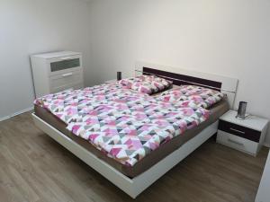 een slaapkamer met een groot bed met roze en witte lakens bij Ferienhaus-Seedo in Herleshausen