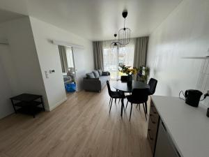a kitchen and living room with a table and chairs at Apartament Przystań 2 in Kartuzy