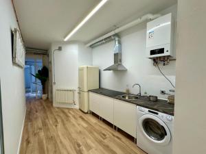 una cucina con frigorifero e lavatrice di Apartamentos Carolina by gaiarooms a León