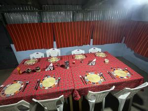 a table with plates and dishes on top of it at leruk Maasai safari camp in Sekenani