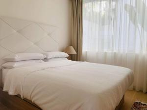 a bedroom with a white bed and a window at Extra large Luxury property with Spa, 3 min to Marbella city center in Málaga +27 photos