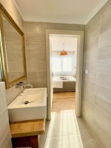 een badkamer met een wastafel en een spiegel en een bed bij Maison individuelle 100 m2, jardin et parking privé in Colmar +33 foto's