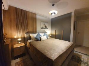 a bedroom with a large bed with two pillows at Tzuba Luxury Home Coresi Mall Brasov in Braşov +38 photos