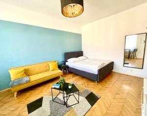 uma sala de estar com uma cama e um sofá em StayHere City Apartment 36 - contactless Self-Check-IN em Graz