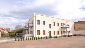 a white building with balconies on the side of it at Barrierefrei I free parking I Terasse I Netflix in Quedlinburg